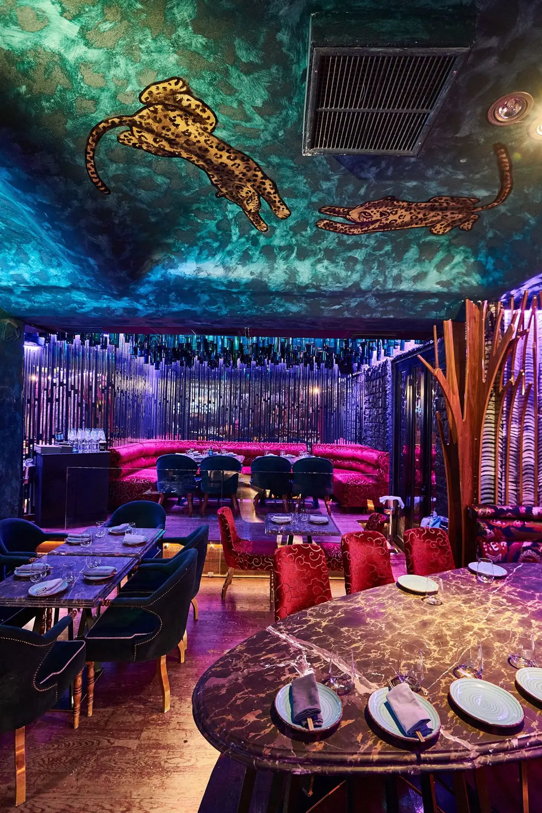 Leopards painted on the teal ceiling above the dining room