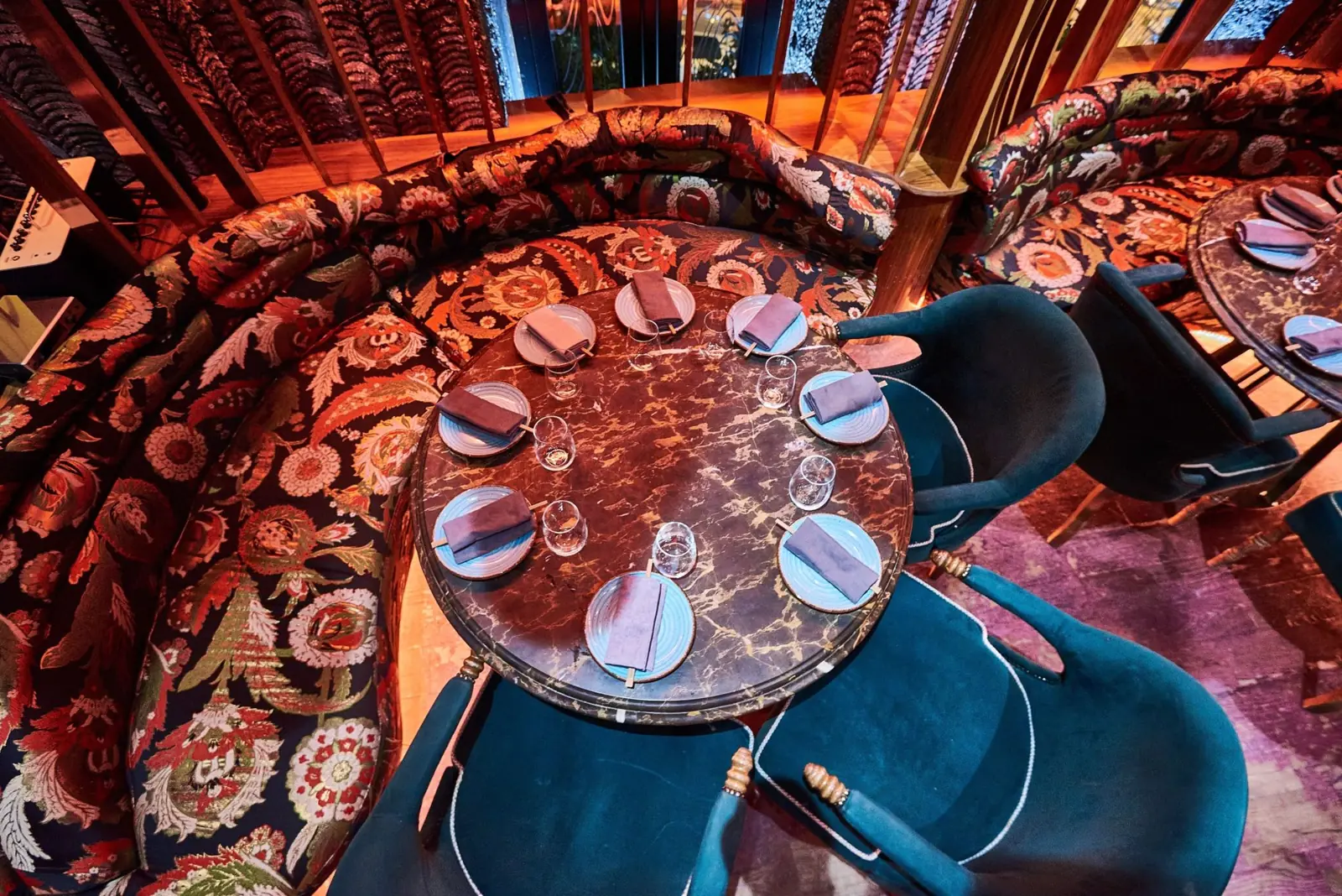 Round marble table in a floral jacquard booth