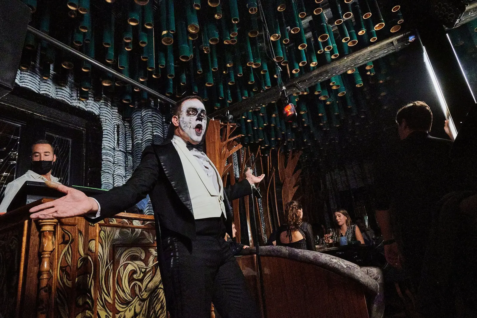 Performer in skull make-up under the bamboo ceiling